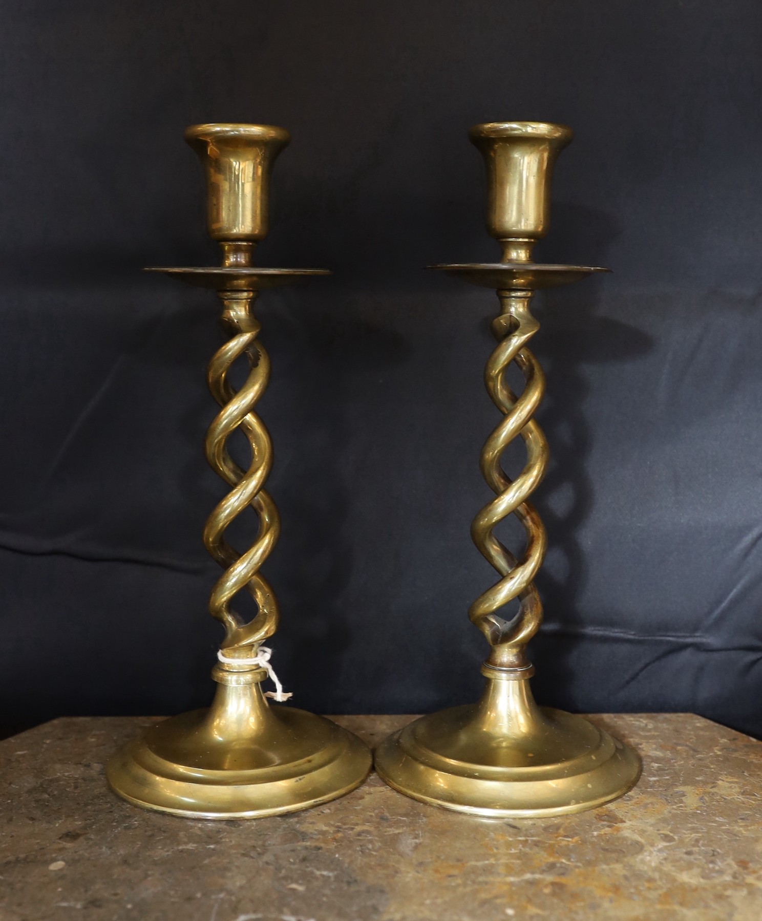 A pair of Victorian brass spiral twist candlesticks and a later seven light candelabrum, candlesticks 27cm. candelabrum 32cm